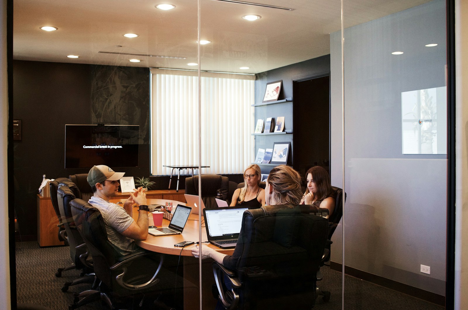 people sitting near table with laptop computer, business